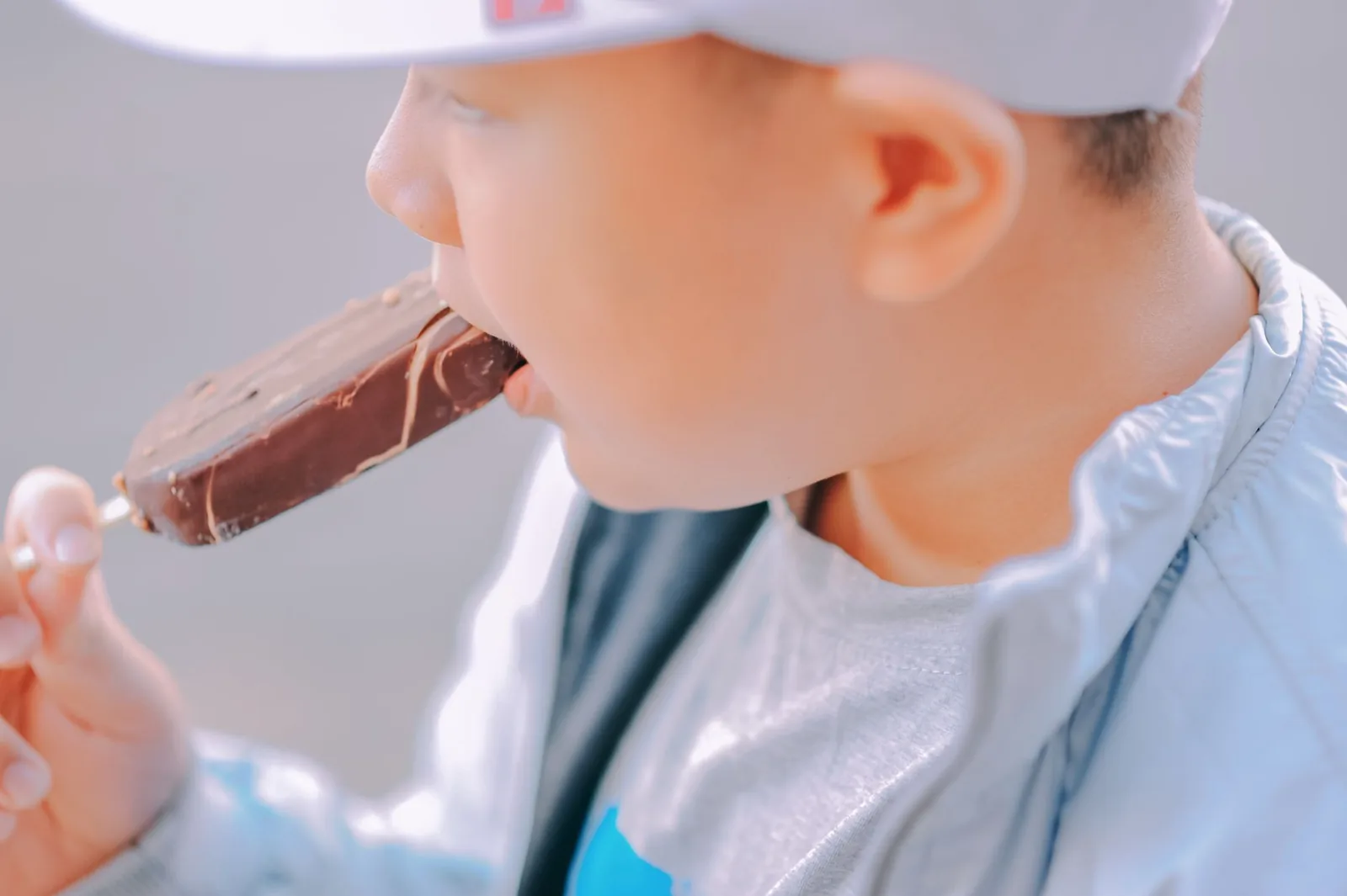 A child eating a chocolate ice cream bar