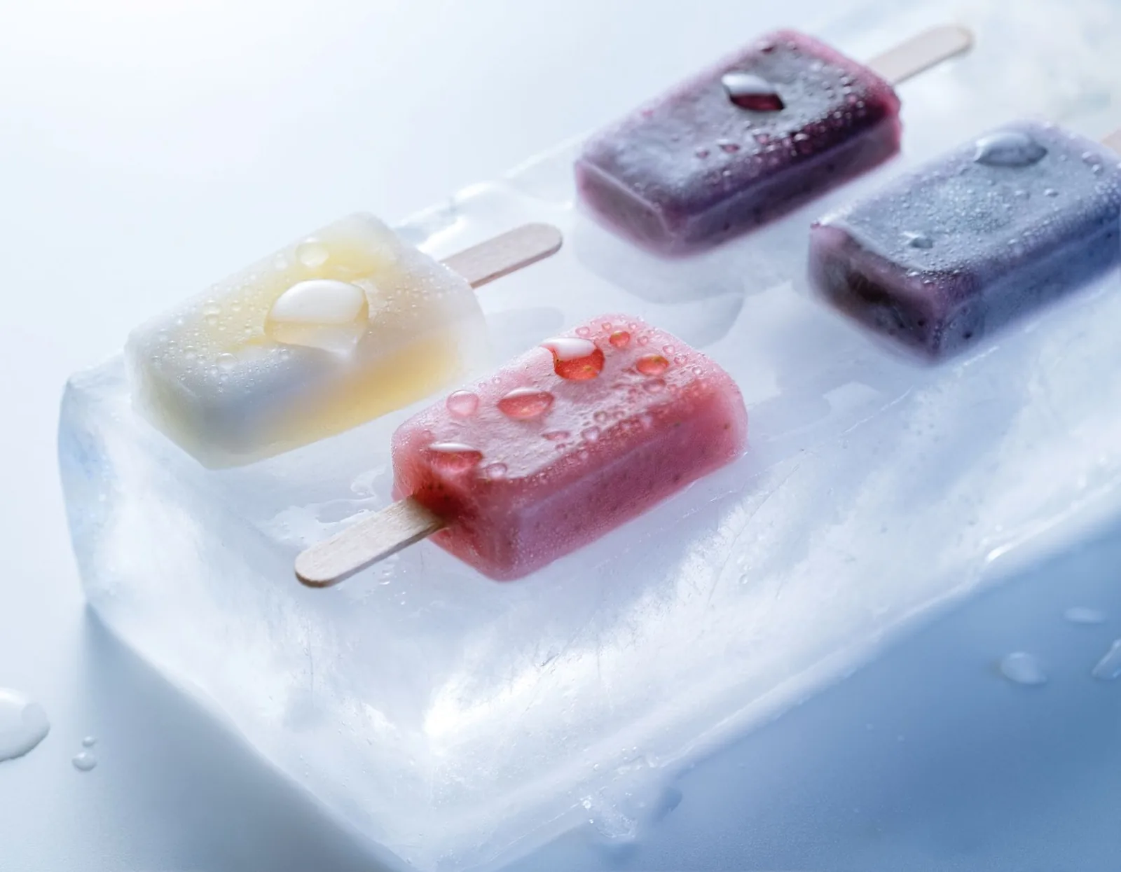 Mixed fruit popsicles on a block of ice