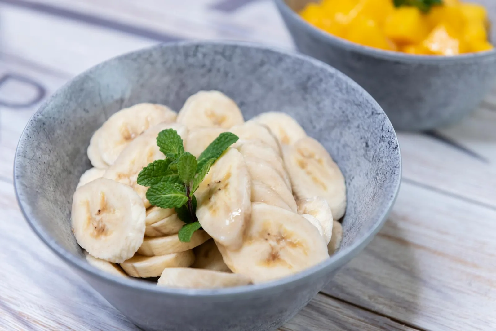 Fresh frozen banana slices in a bowl, a whole-food base for dairy-free shakes