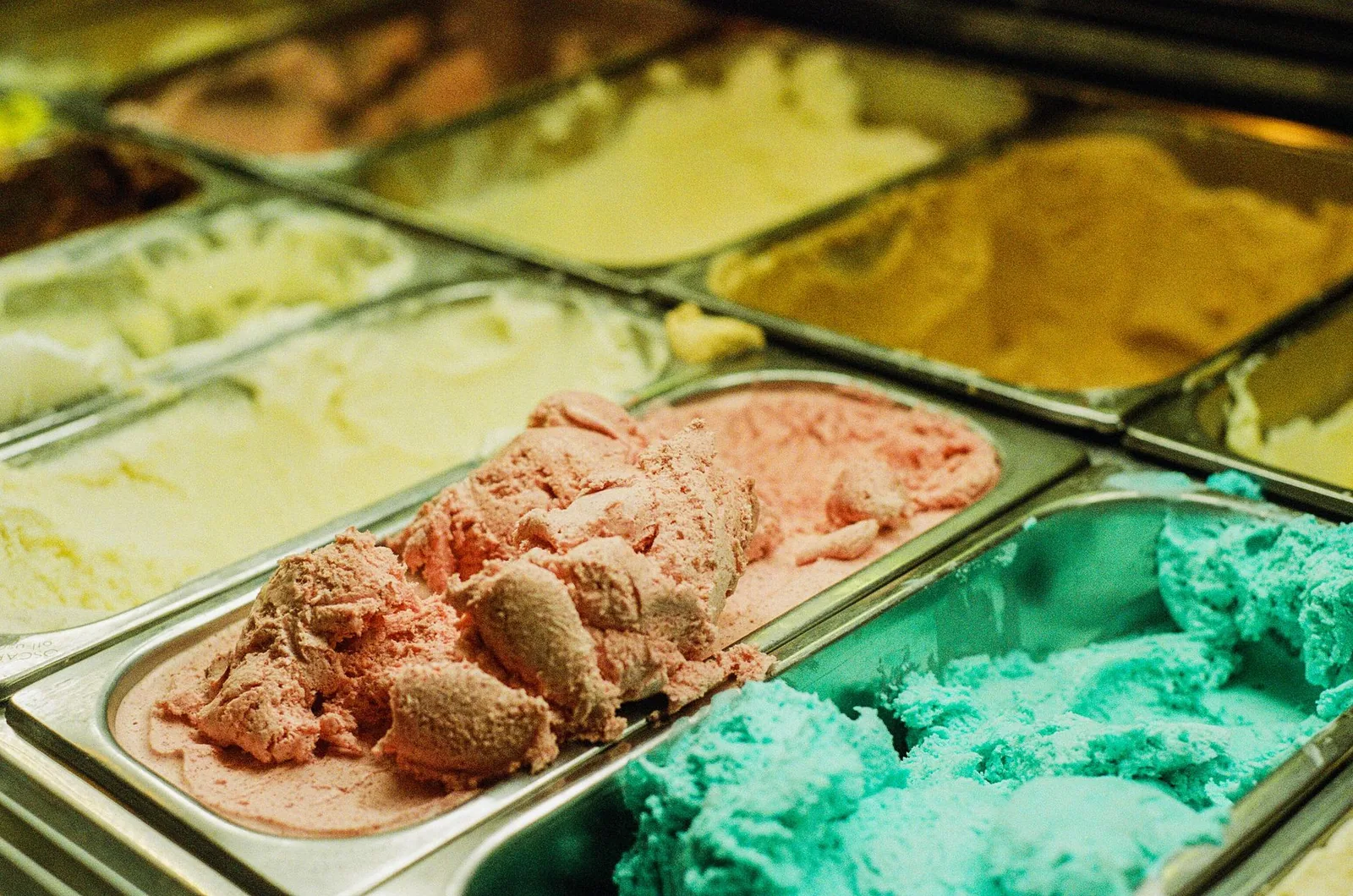 Various flavors of ice cream on display in a shop freezer case